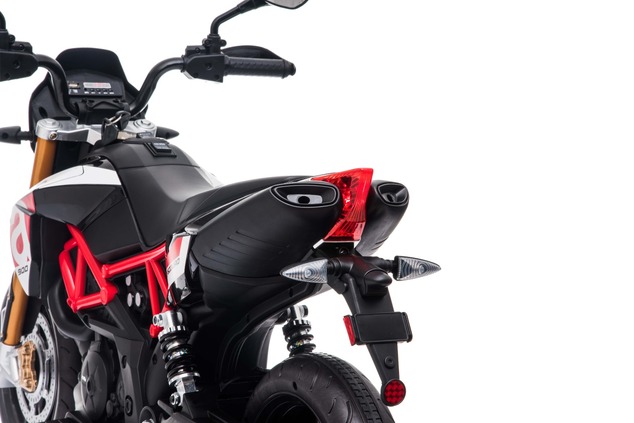 Moto électrique enfant APRILIA DORSODURO 900 sous licence, batterie 12V, roues EVA souples, 2 × 18 W